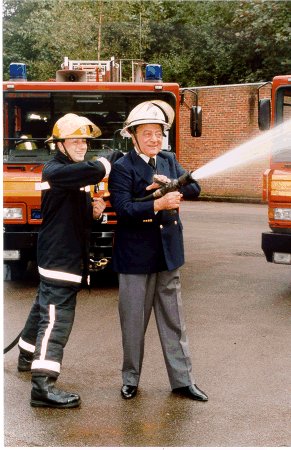 Picture of Mohamed Al Fayed being shown how to operate a High Pressure Hose Reel at the Oxted Firestation open day, September 2000.